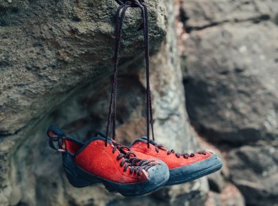 red climbing shoes on stone rock otdoor
