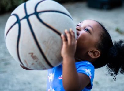 toddler playing with basketball