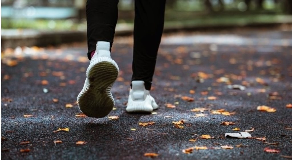 faceless man running on road