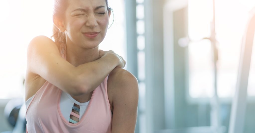 woman get accident between workout in gym shoulder pain